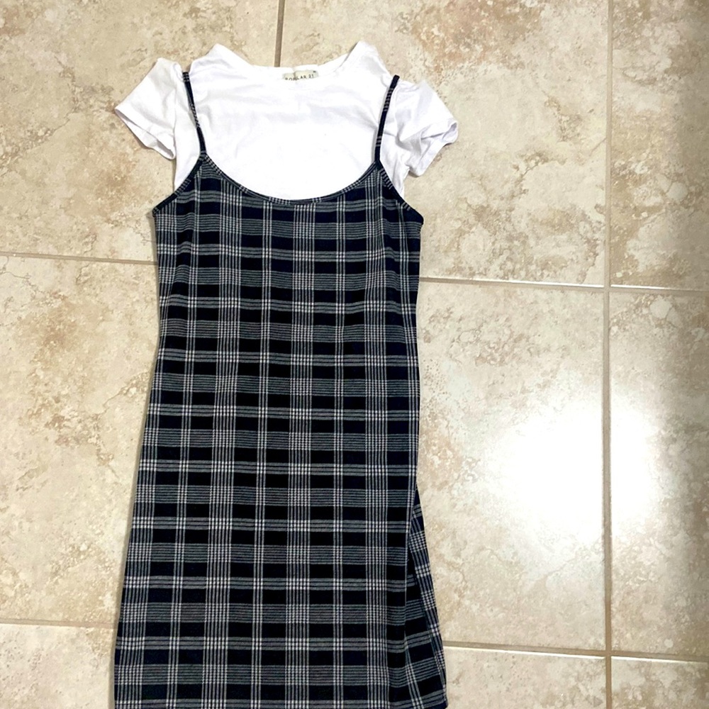 Dress with a plaid like print and a white top.